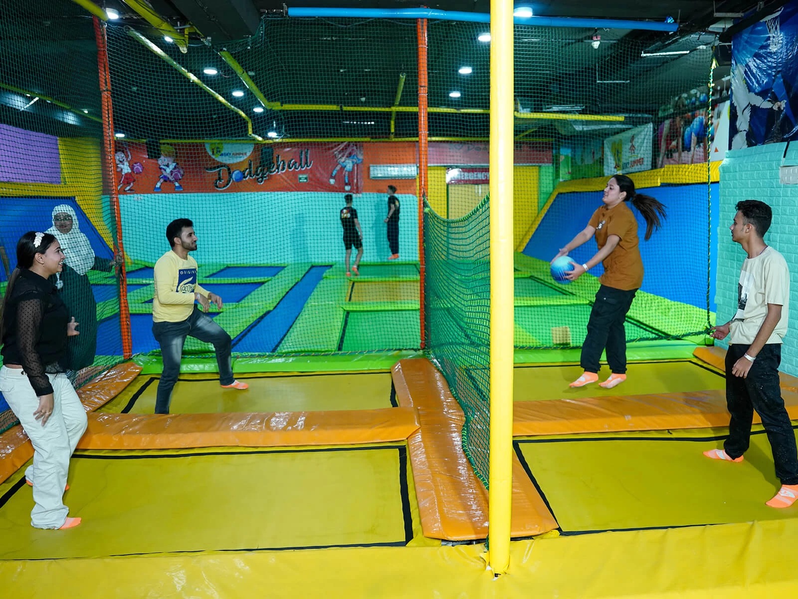 people playing volley ball on trampoline