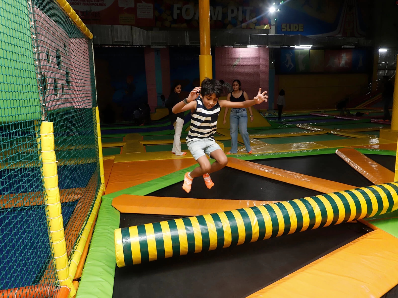 kid playing wipe out at skyjumper