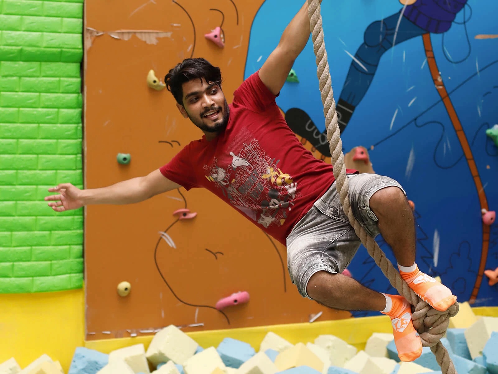 a guy posing for a photo while swinging